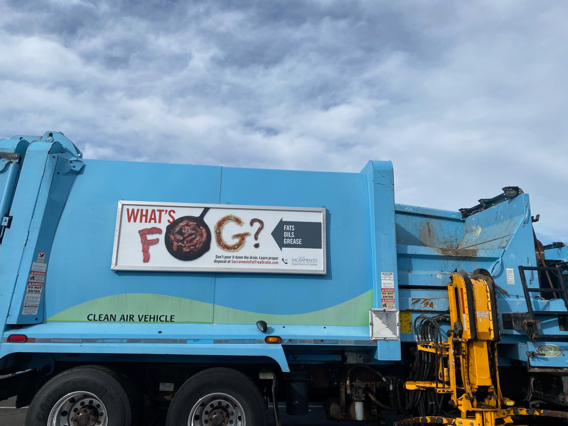 Roadway frame on a Sacramento truck with a fats, oils and grease disposal awareness panel