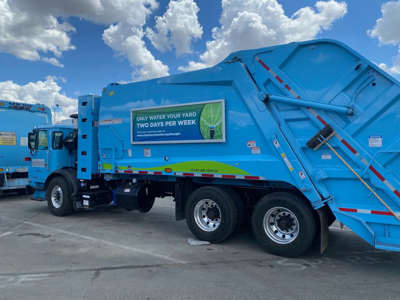 City of Sacramento collection truck carrying a Roadway Displays quick-change frame with a water-conservation campaign panel.